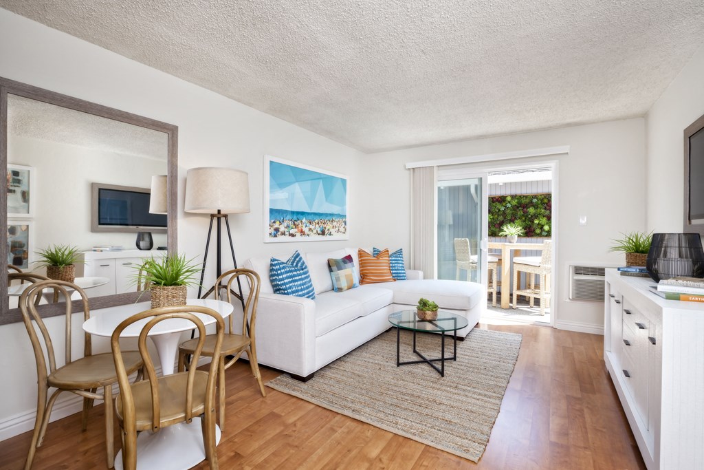 a living room with a white couch and a table and chairs