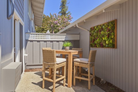 a dining area with a table and chairs on a patio