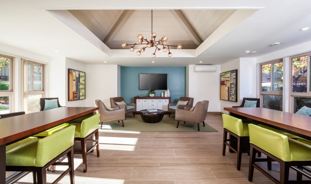 a dining room and living room with a table and chairs