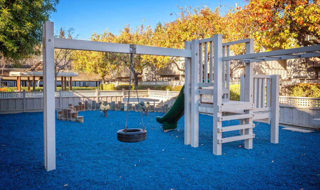 a playground with a slide and a swing set
