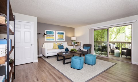 an open living room with a sliding glass door to a balcony
