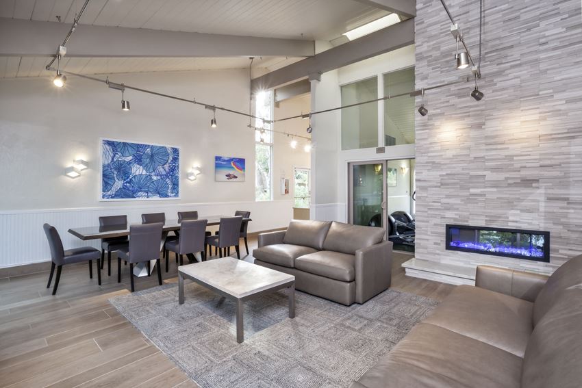 a living room with a fireplace and a table with chairs