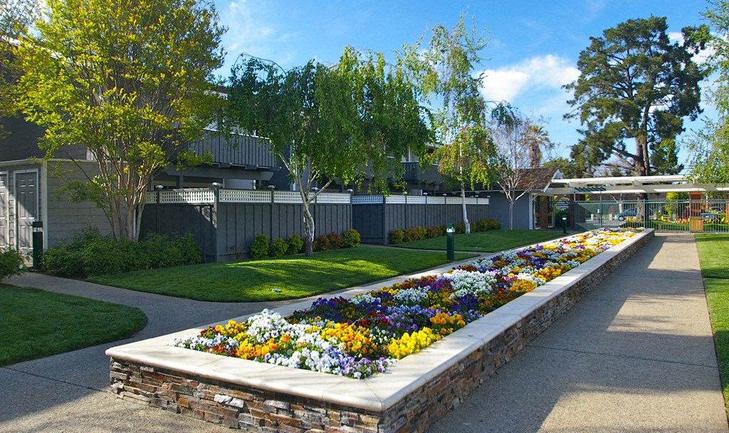 a flower garden in front of a house