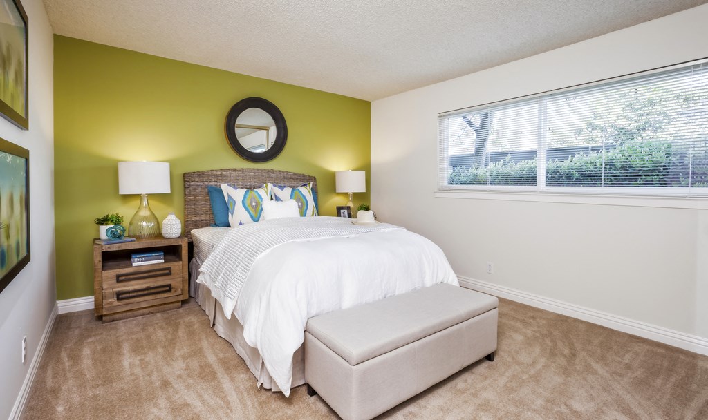 a bedroom with a large bed and a window