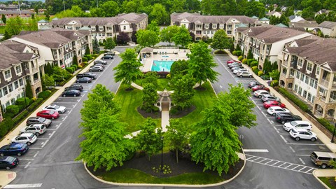 an aerial view of a neighborhood with a swimming pool in the middle of a street
