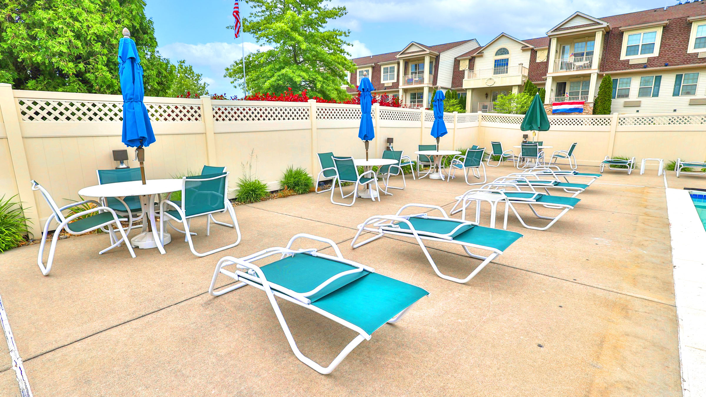 our patio is full of chairs and tables and umbrellas
