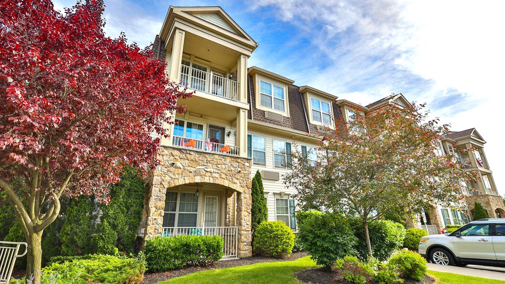 an apartment building with a car parked in front of it