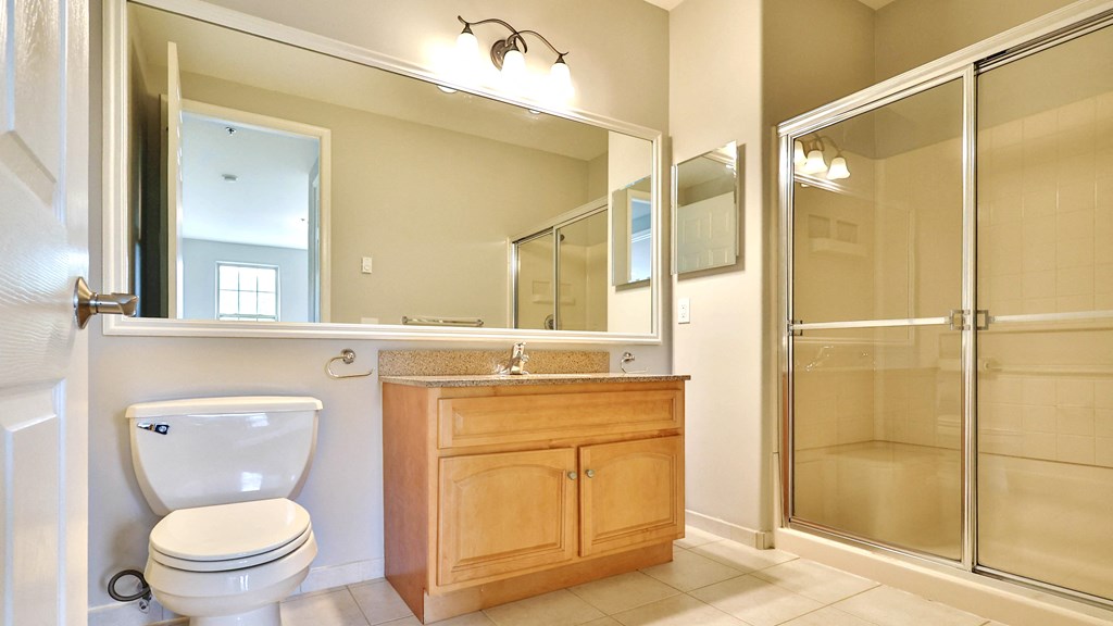 a bathroom with a toilet and a sink and a shower