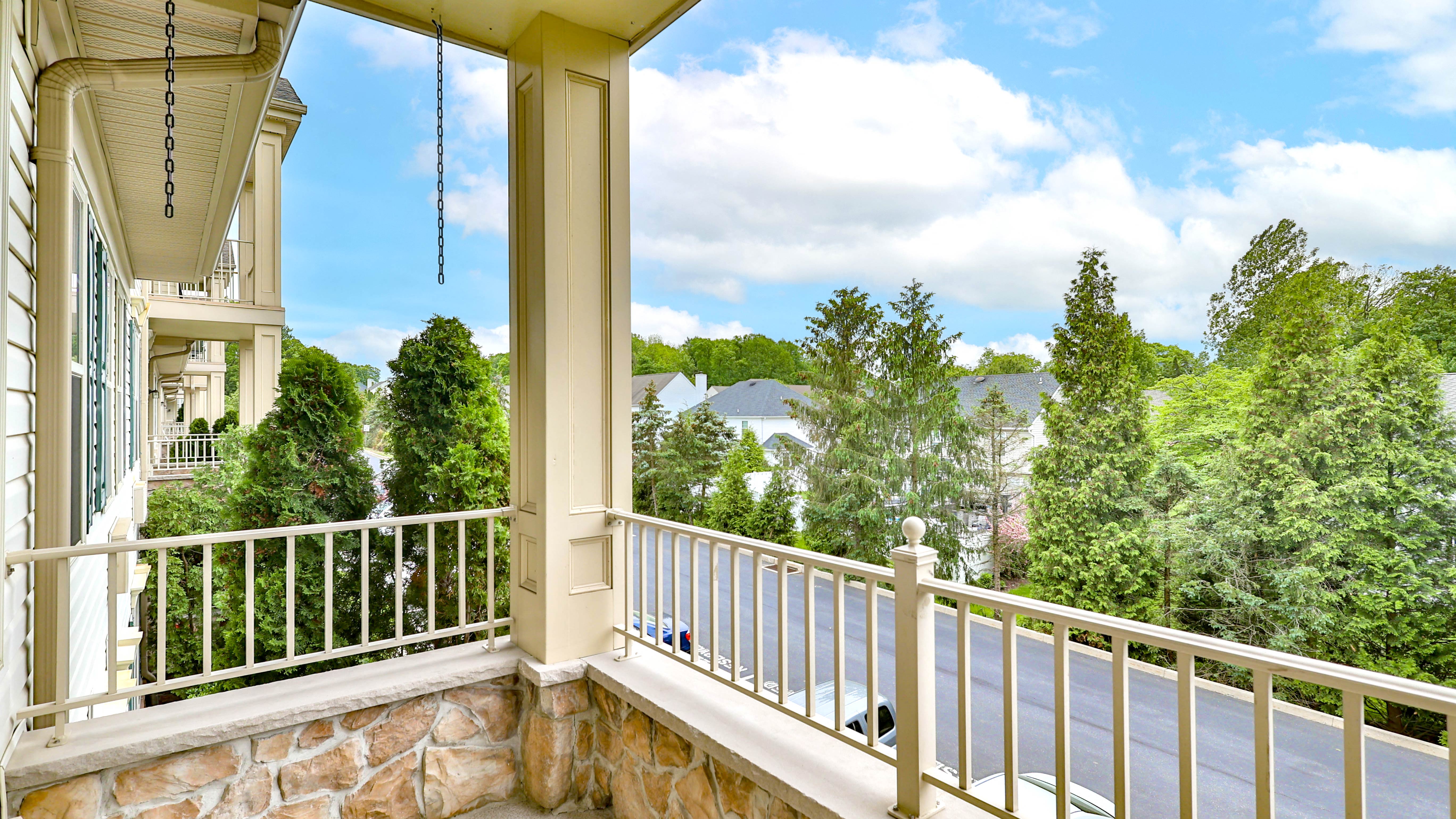 a balcony with a view of trees and a house