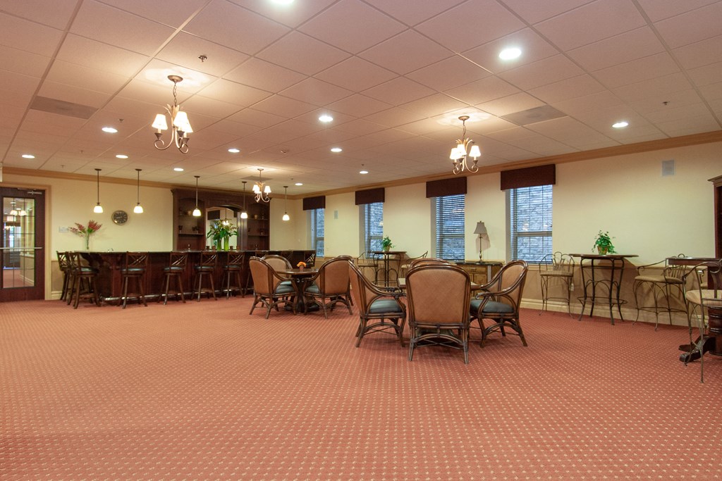 a conference room with tables and chairs and chandeliers