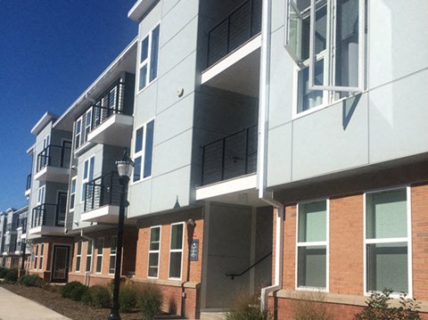 a row of apartment buildings on a city street