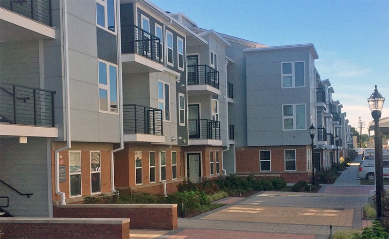 a row of apartment buildings on a city street