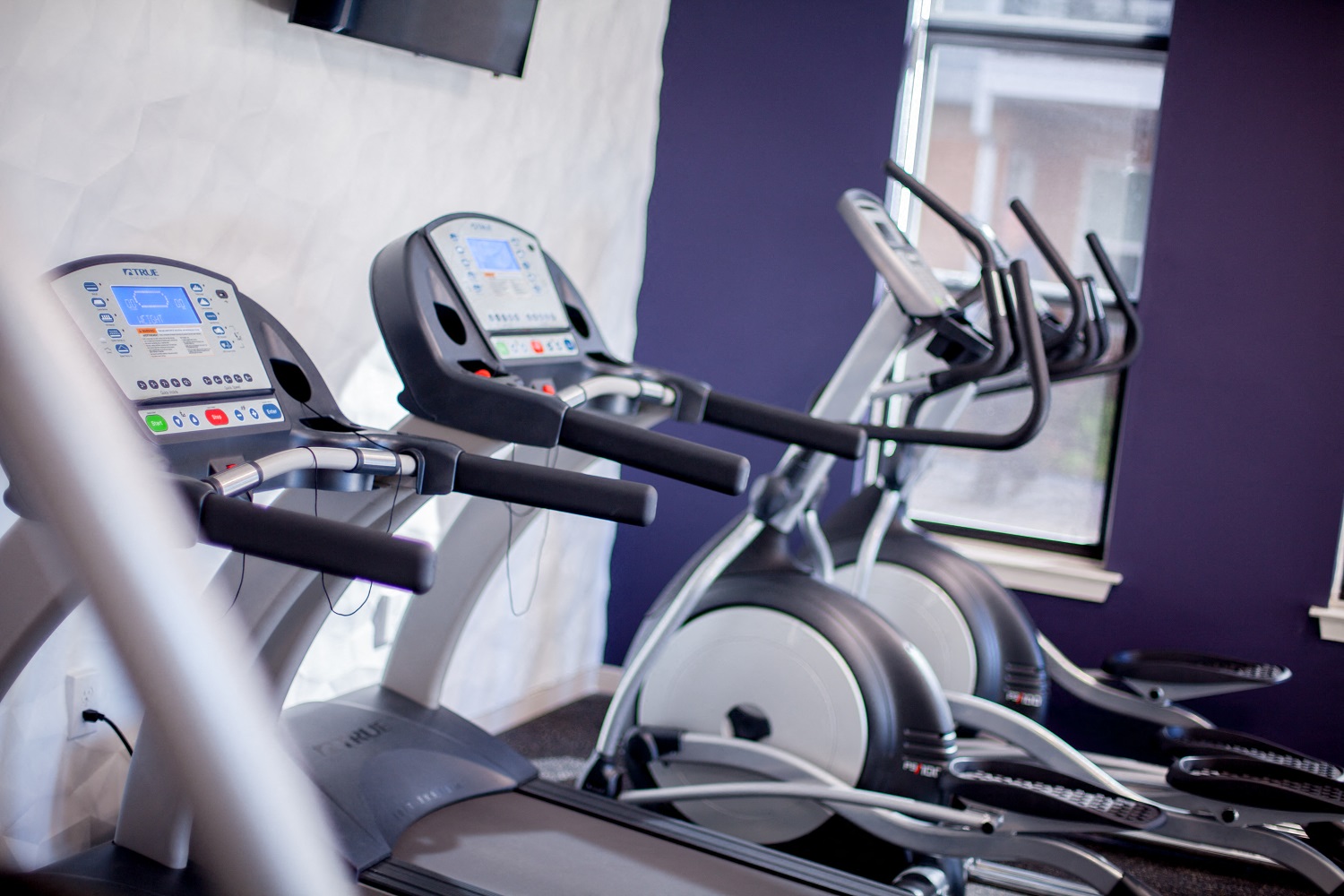 a row of exercise bikes in a gym