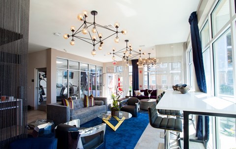 a living room with couches and chairs and a large chandelier