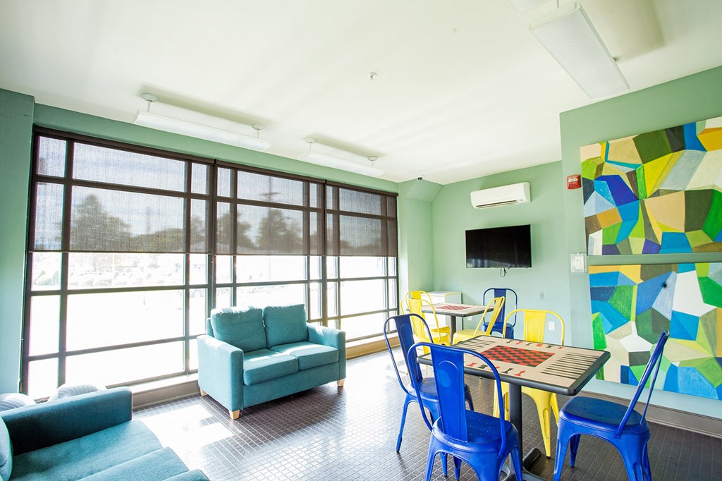 a living room with a table and chairs and a large window