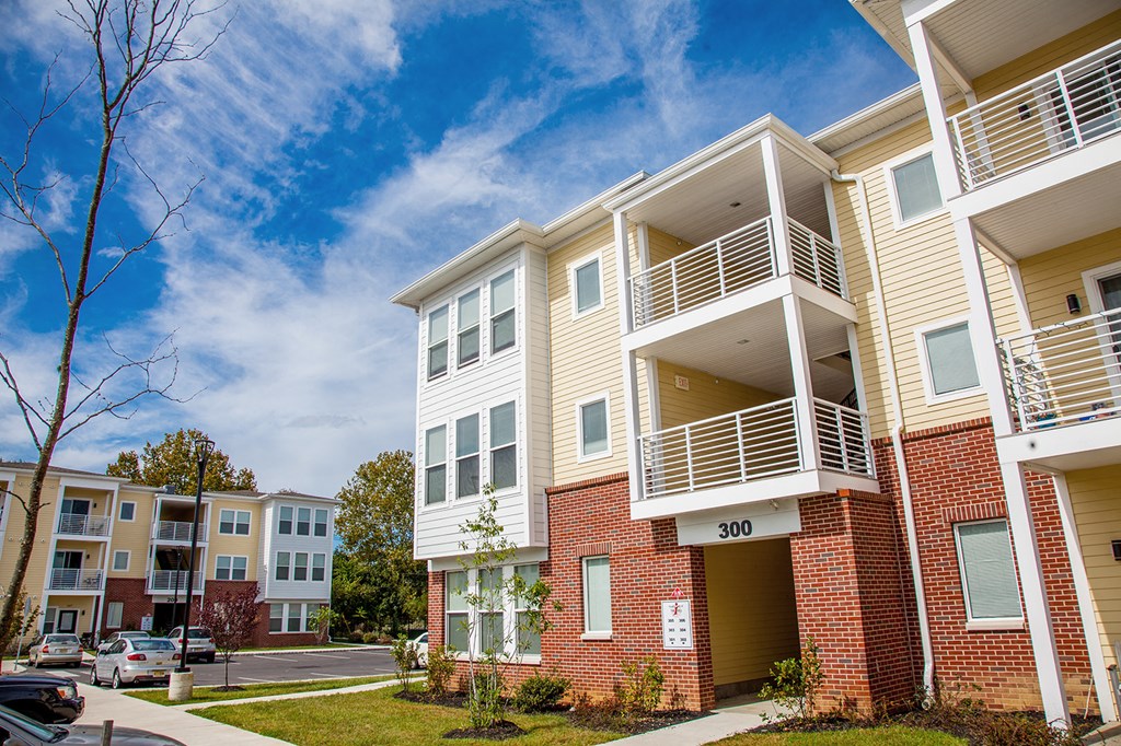 an apartment building with a blue sky in the background