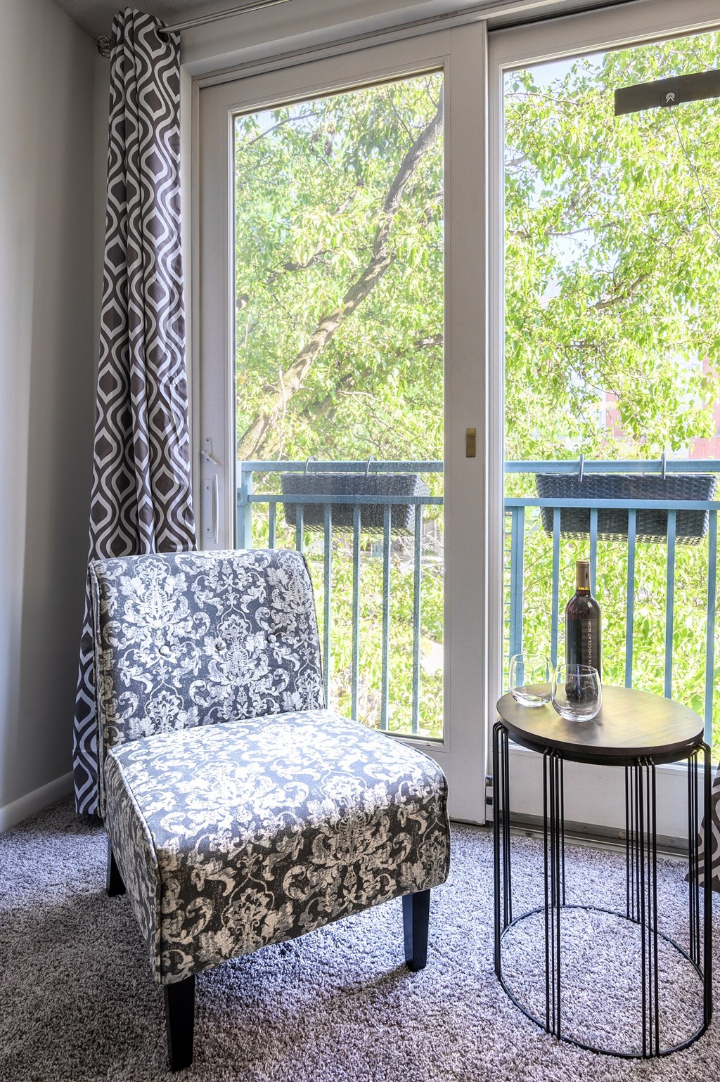 a room with a chair and a table in front of a window
