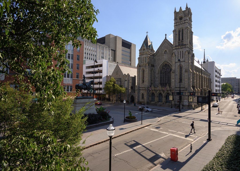 an empty city street with a church and a tall building