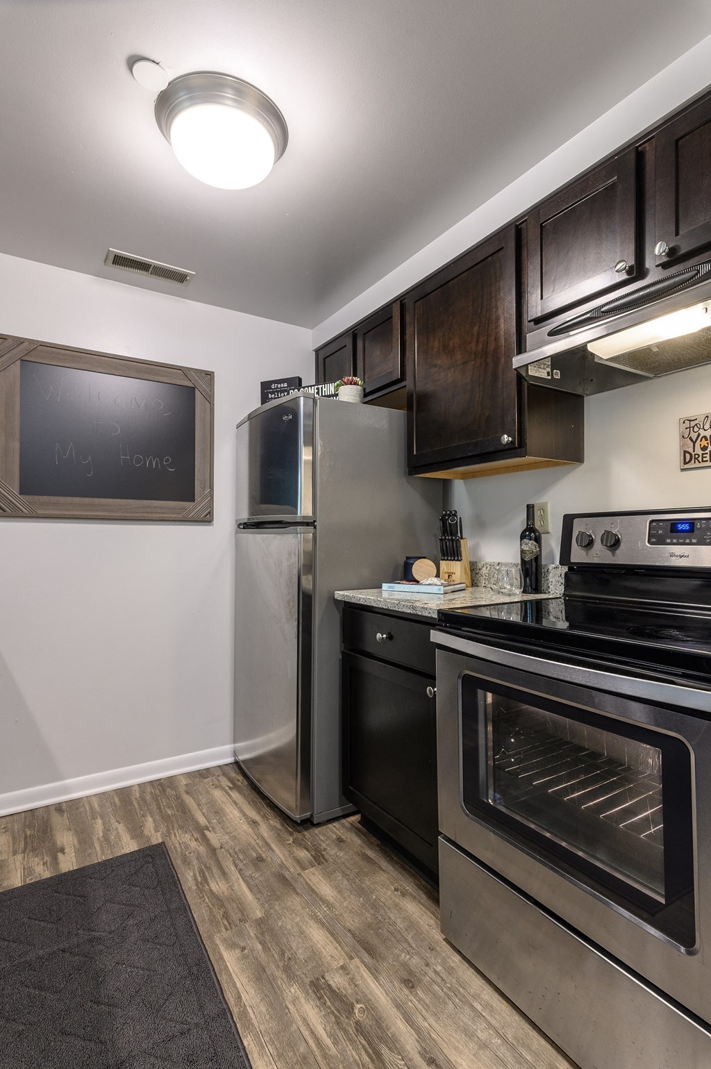a kitchen with stainless steel appliances and a tv