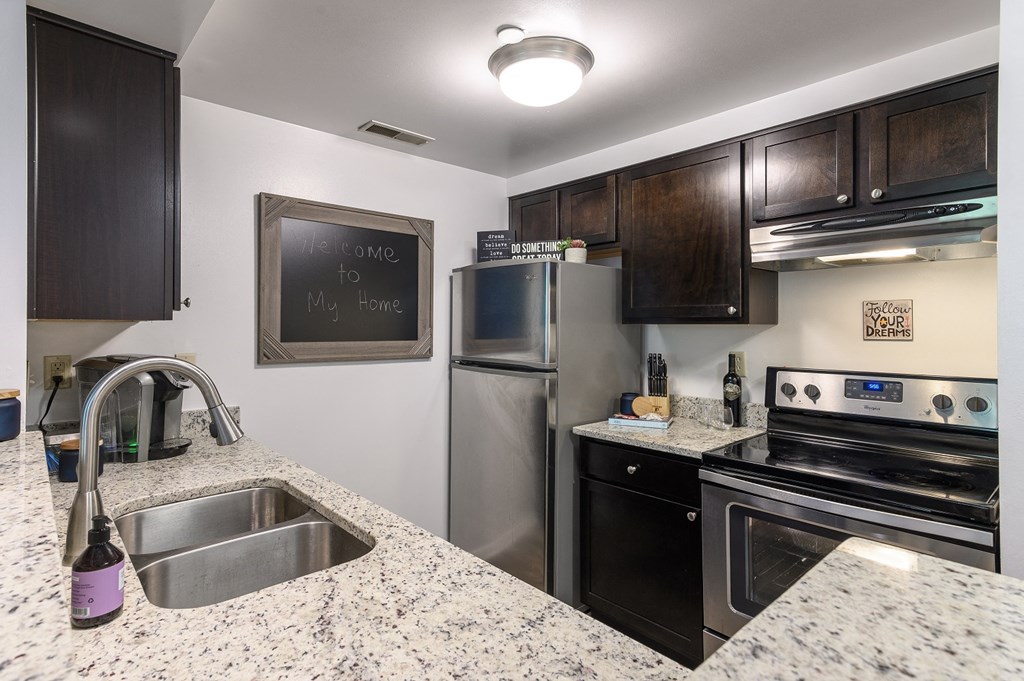 a kitchen with stainless steel appliances and granite counter tops