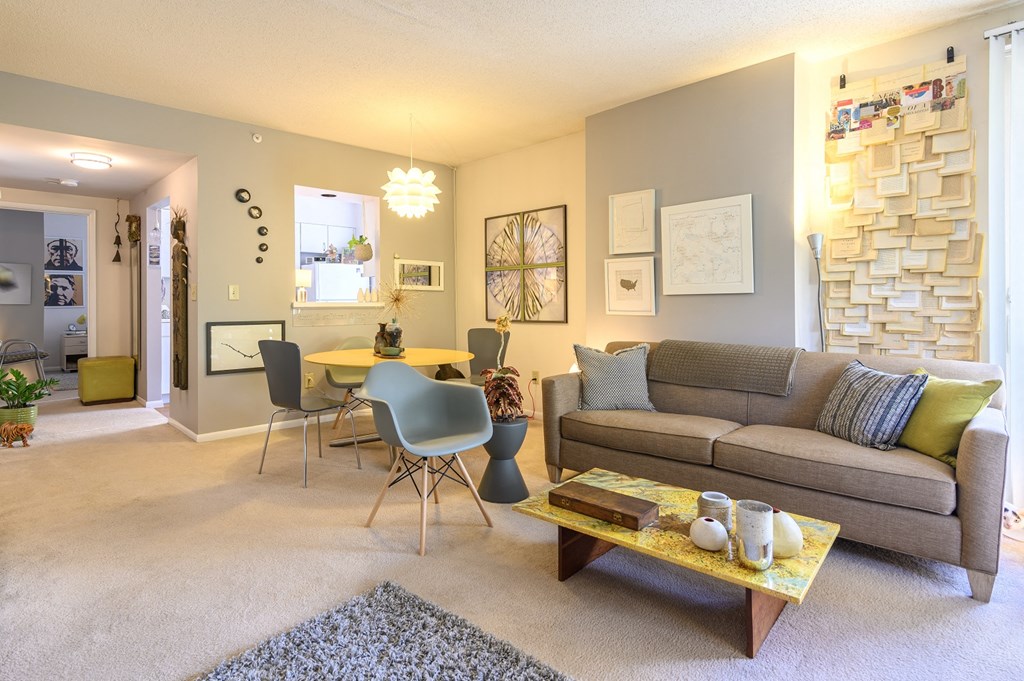 a living room and dining room with a couch and a table
