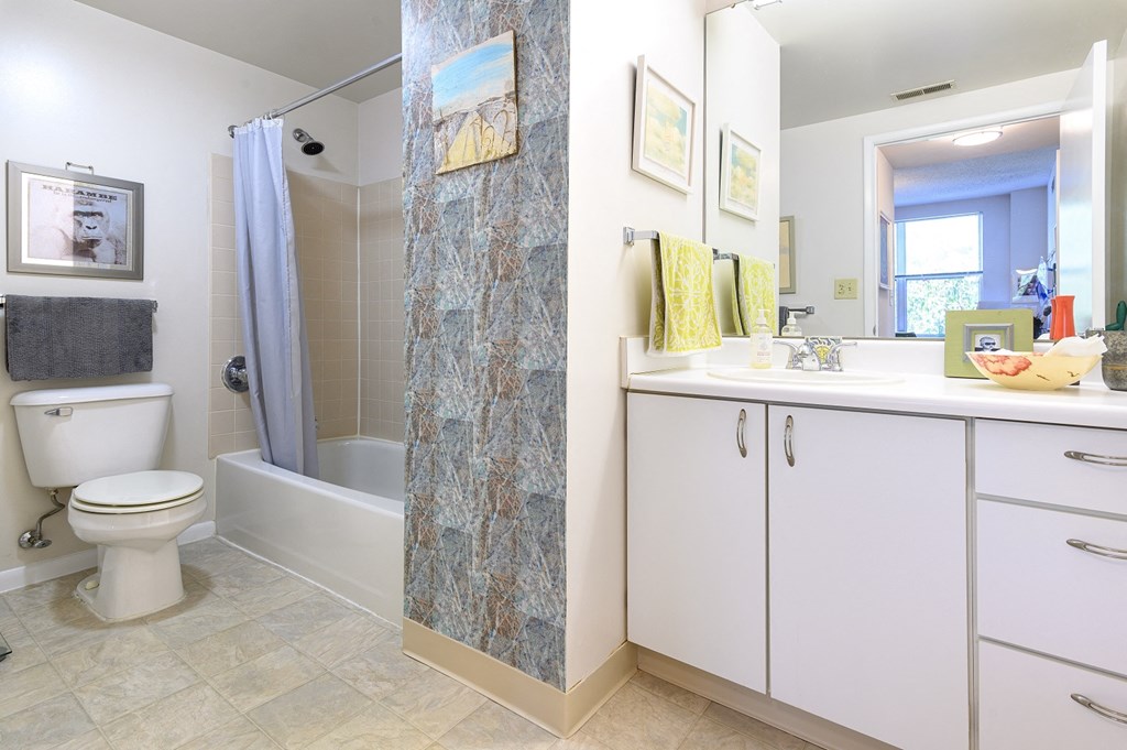 a bathroom with a shower and a sink and a toilet