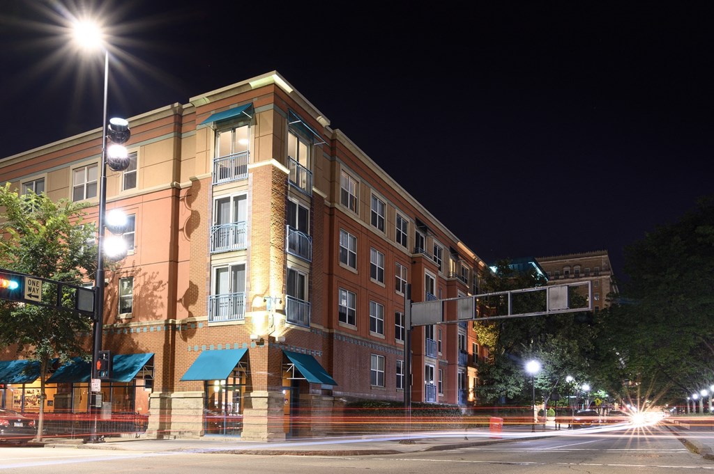 a large brick building at night with street lights