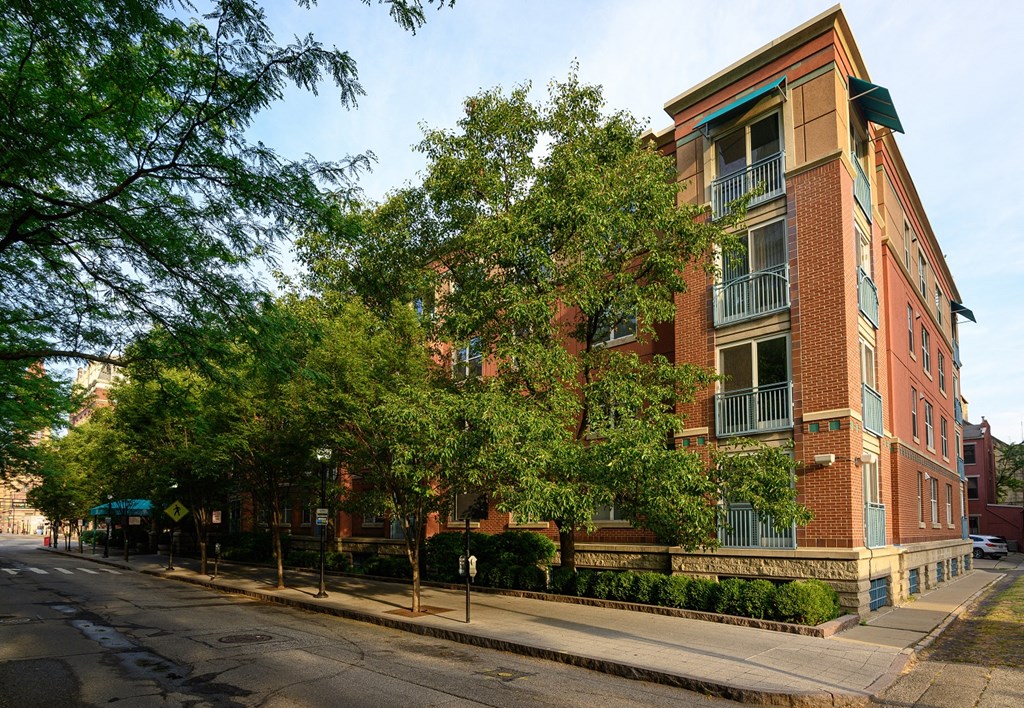a red brick apartment building on the corner of a street
