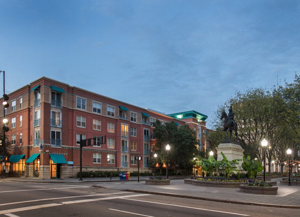 a large brick building on a street corner at night