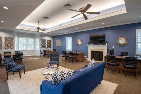 a living room with a couch and chairs and a fireplace