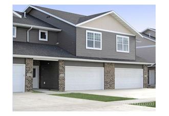 a house with two garage doors in front of it