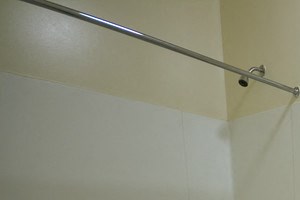 bathroom with white cabinet, white tile floor, and off white walls
