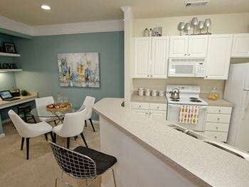 Crisp white cabinets and granite inspired counter tops give your kitchen a bright inviting feel at Abberly Place at White Oak Crossing by HHHunt,  Garner, 27610