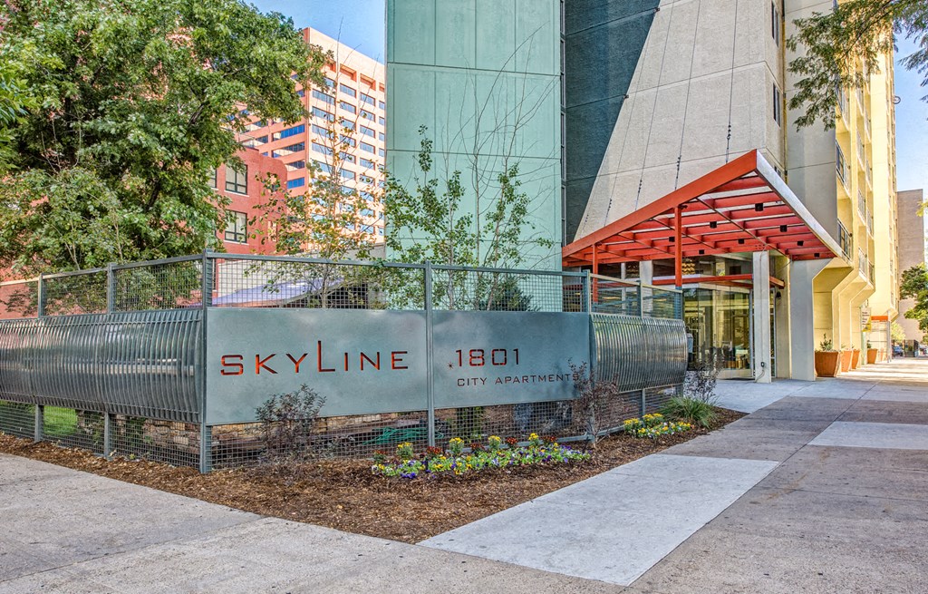 a fence in front of a building with the skyline headquarters sign
