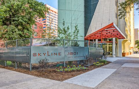 a fence in front of a building with the skyline headquarters sign