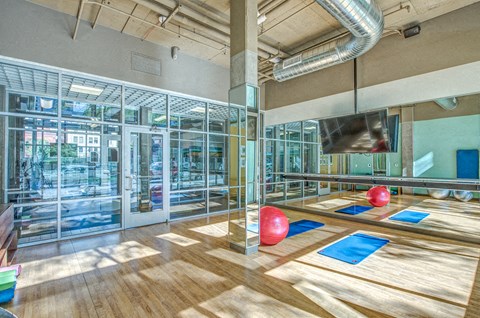 a bowling alley in a gym with red bowling balls
