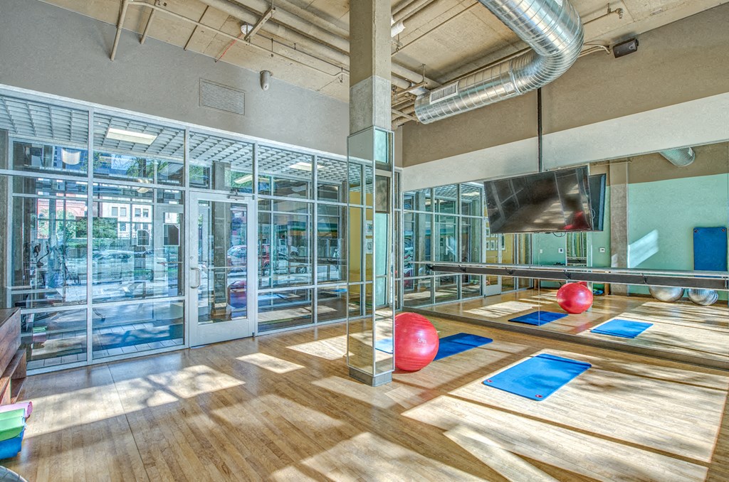 a bowling alley in a gym with red bowling balls