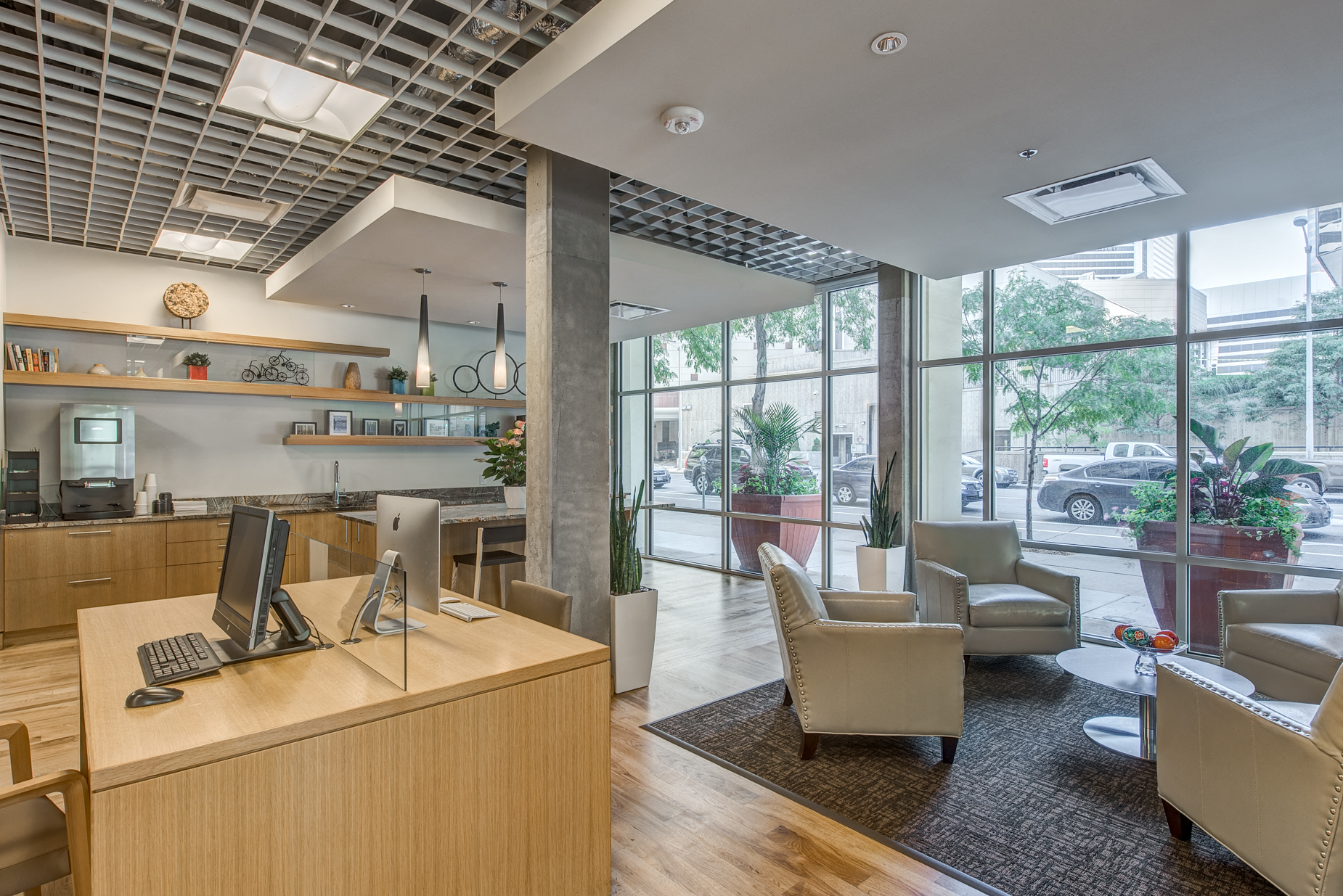 a lobby with couches chairs and a desk with a computer