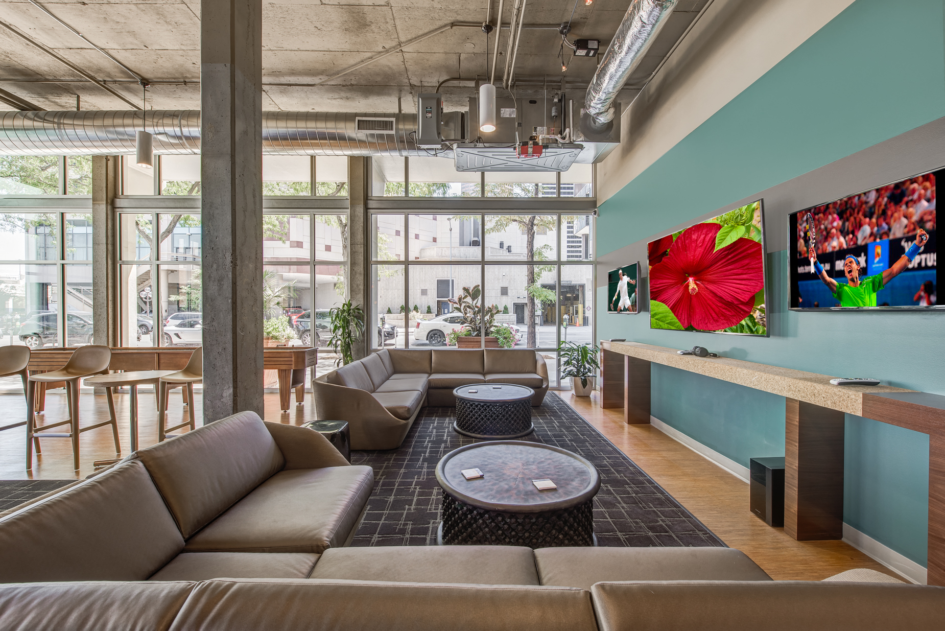 a living room with couches and a coffee table in front of a large window