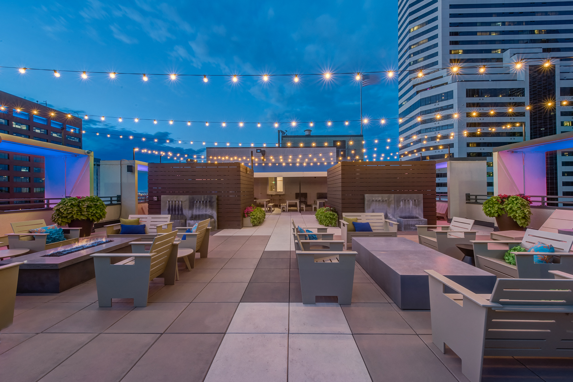 a rooftop restaurant with tables and chairs and lights