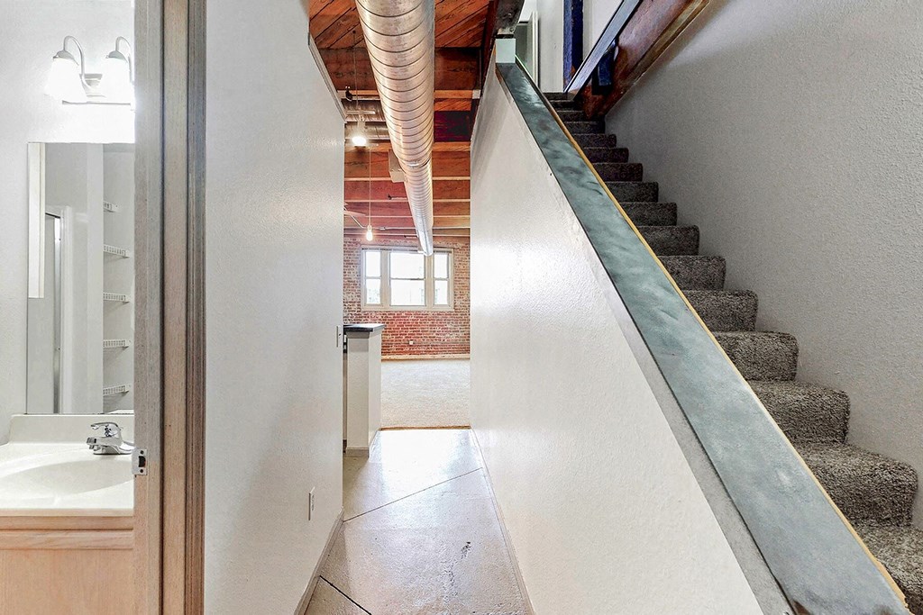 a stairway leading to a bathroom next to a staircase
