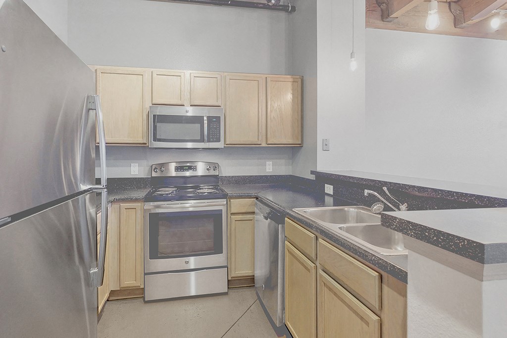 a kitchen with stainless steel appliances and wooden cabinets