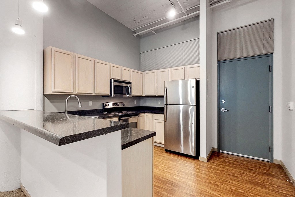 a kitchen with a counter top and a refrigerator
