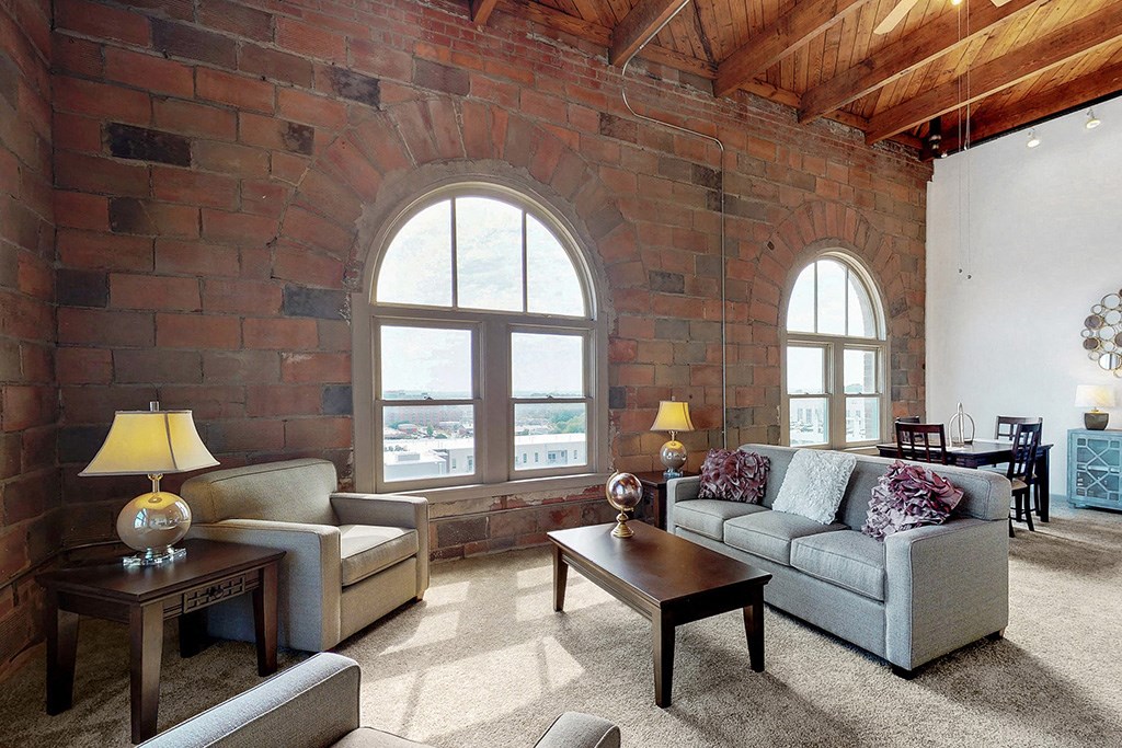 the living room has a brick wall and a large window