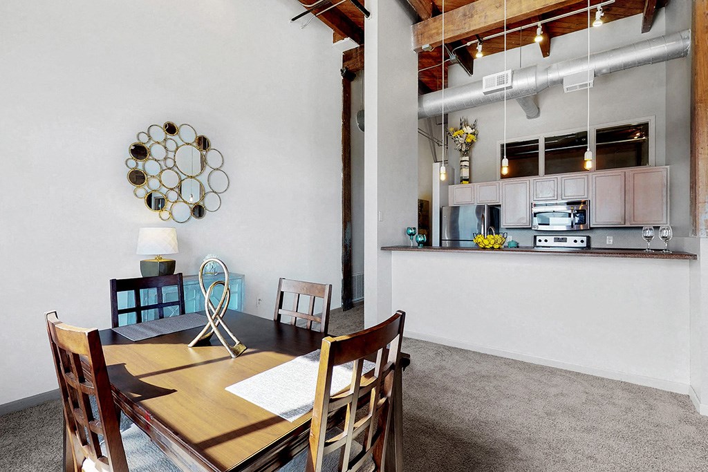 a dining room with a table and chairs and a kitchen