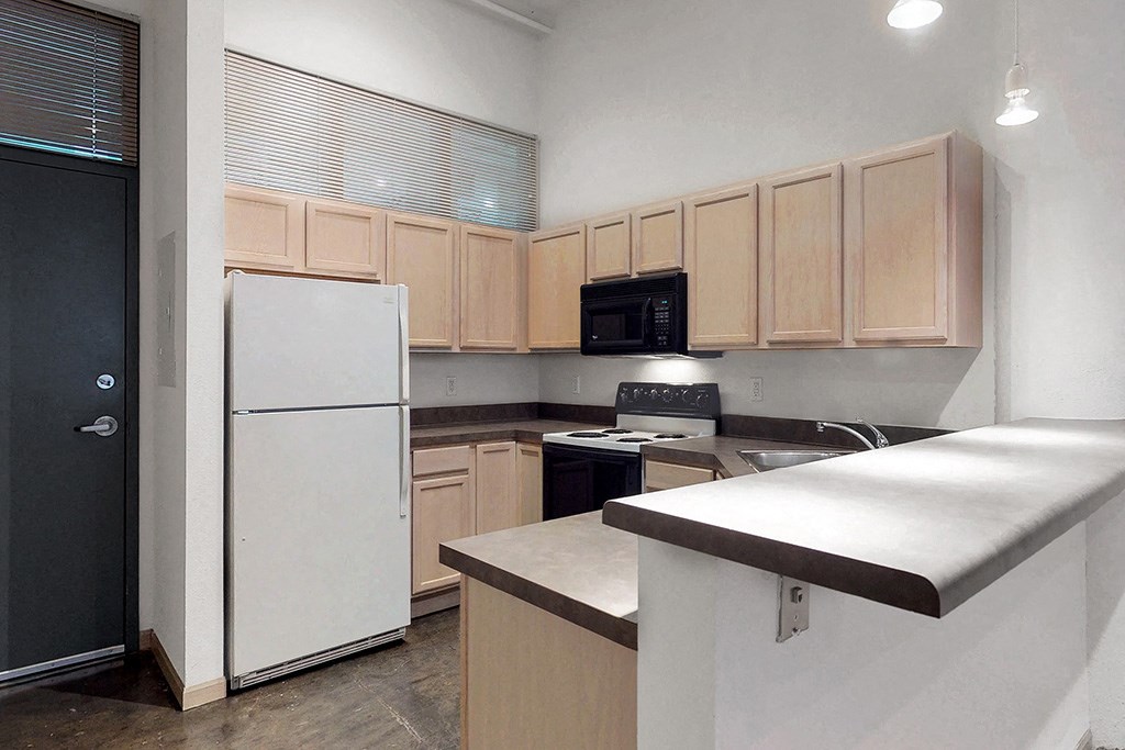 a kitchen with wooden cabinets and a white refrigerator
