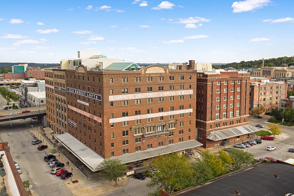 an aerial view of a large brick building in a city