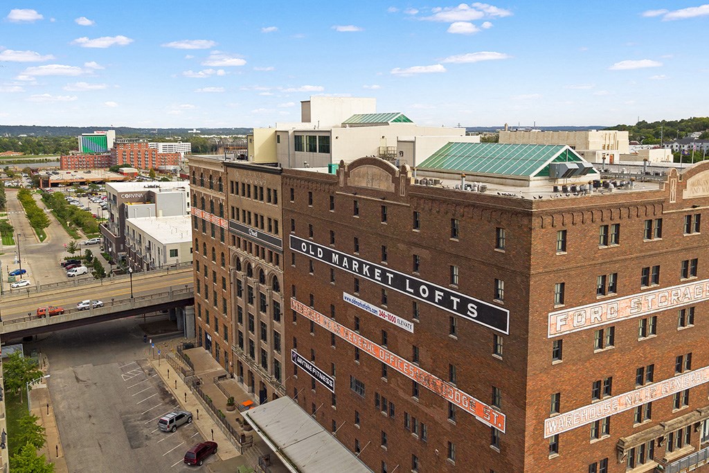 an aerial view of a building in a city with a bridge