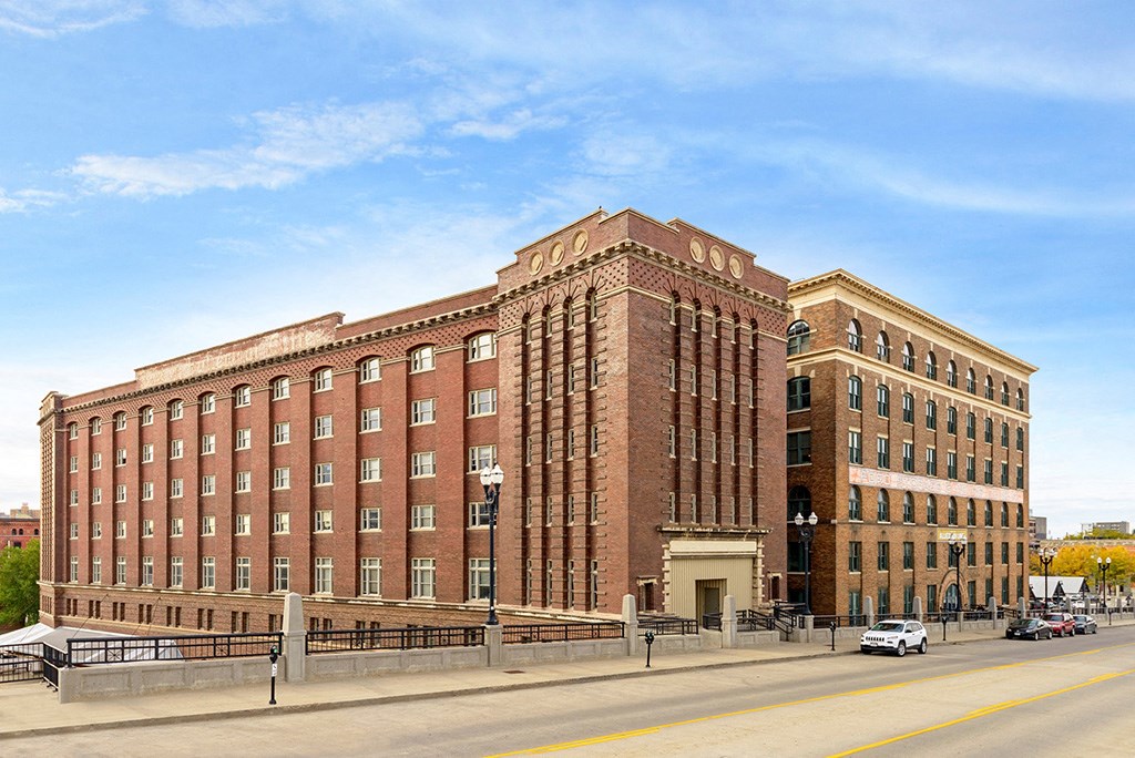 a large brick building with a street in front of it