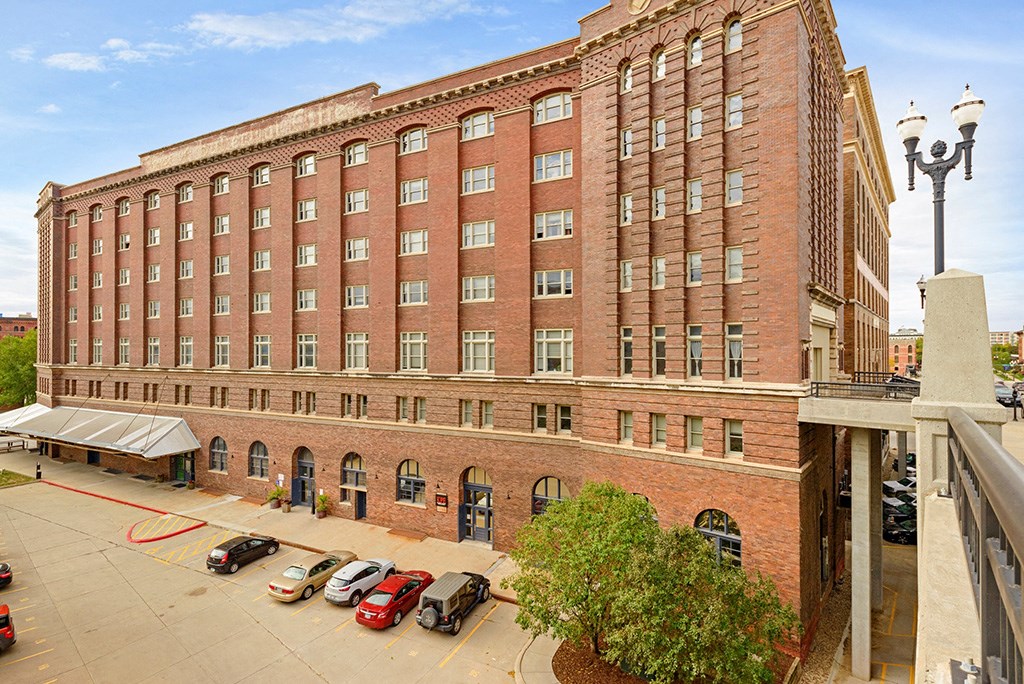 a large brick building with cars parked in front of it